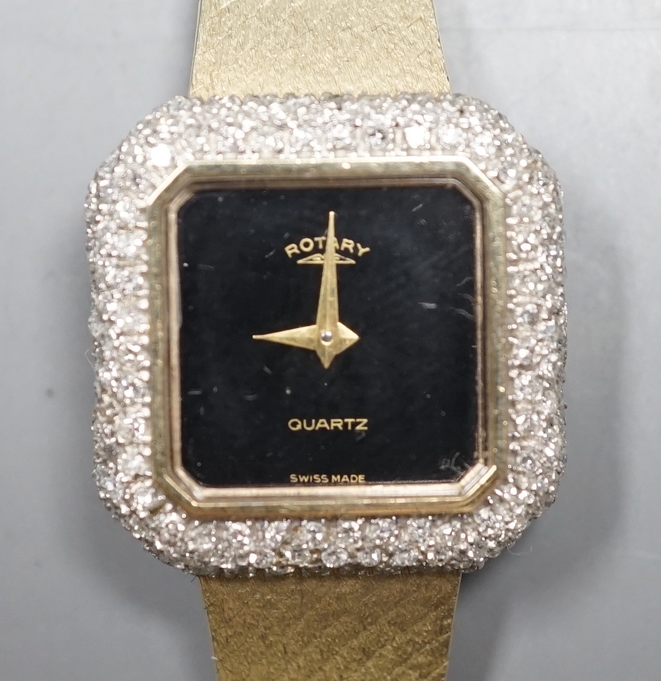 A lady's 9ct gold and diamond set quartz wrist watch, overall length 17.2cm, gross weight 33.3 grams, on 9ct gold strap.